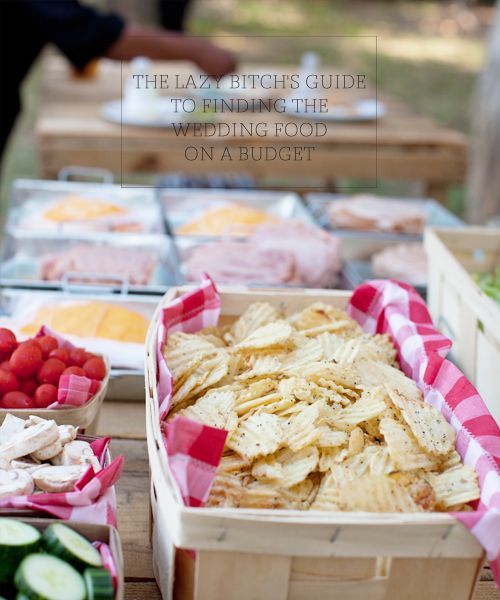 an assortment of food is displayed on a picnic table with red and white checkered napkins