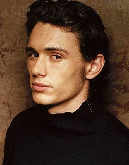 a young man in a black turtle neck sweater looking at the camera with a serious look on his face