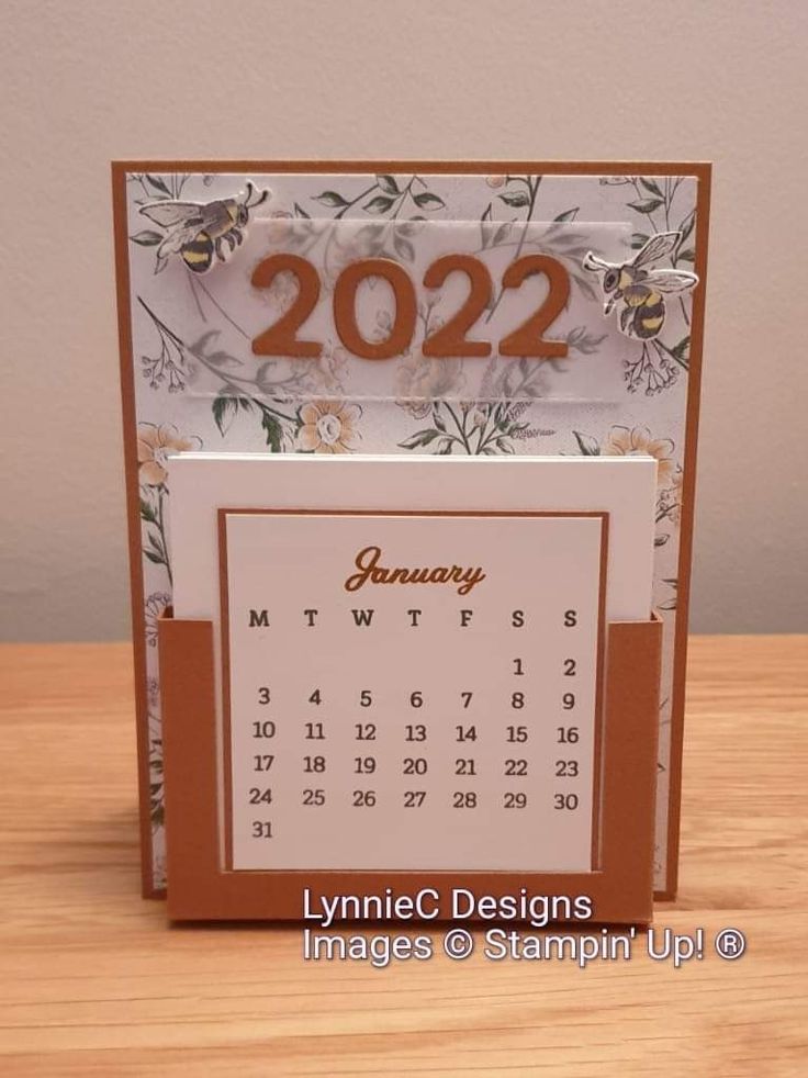 a desk calendar card with the year 2012 on it, sitting on top of a wooden table