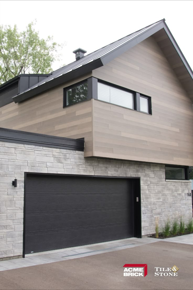 a large house with two garage doors and windows