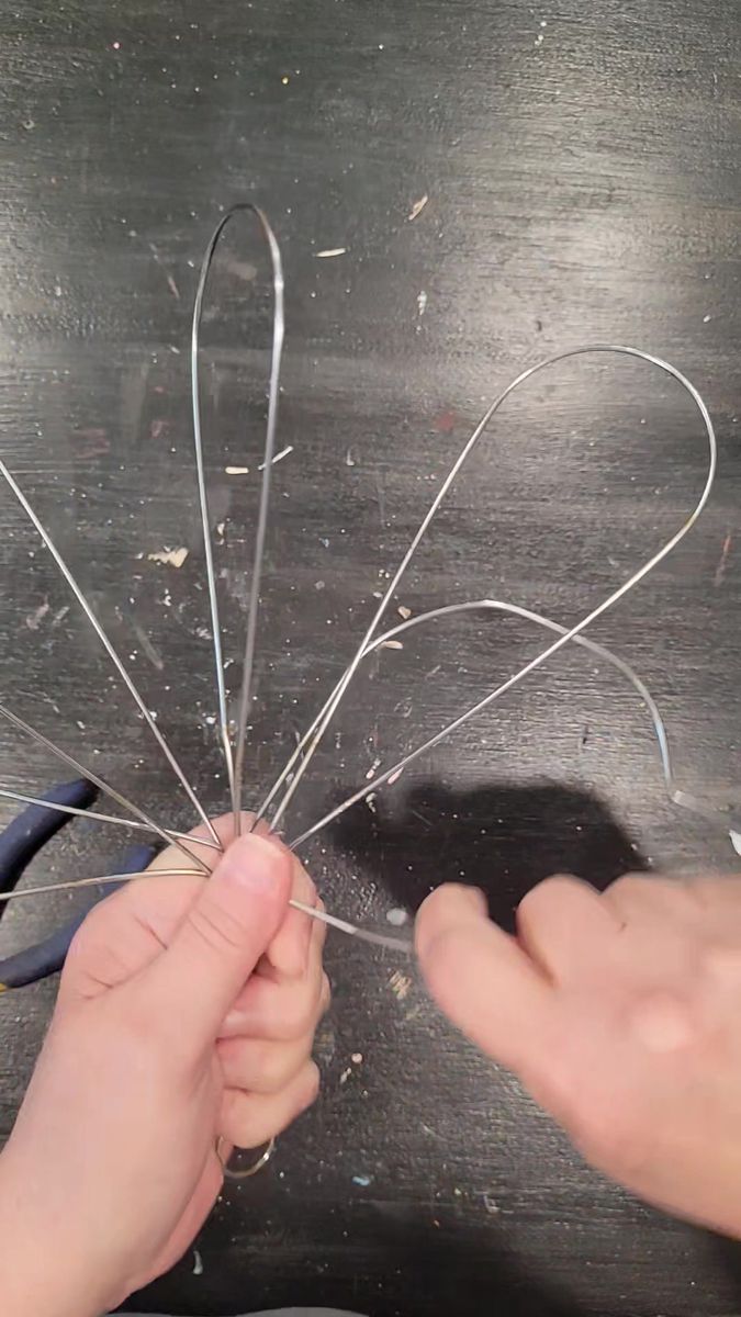 someone is working with wire and scissors on the table