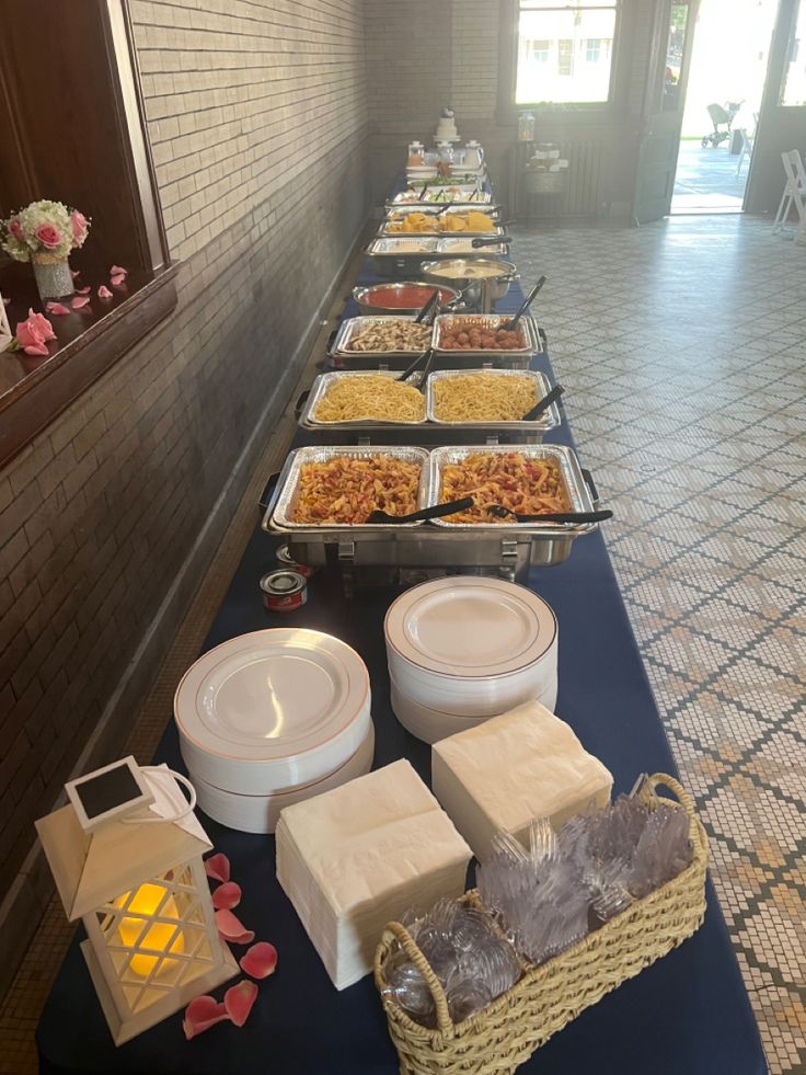 a buffet line with many different types of food on it's trays and containers