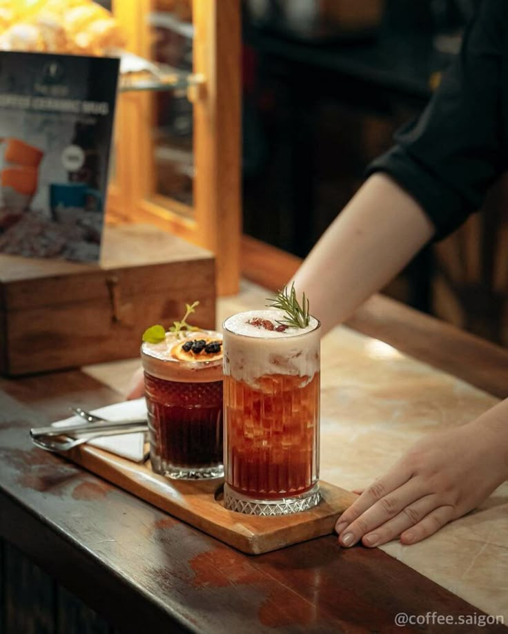 two drinks sitting on top of a wooden table