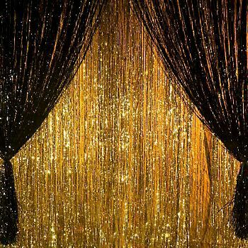 a gold curtain with black curtains and lights