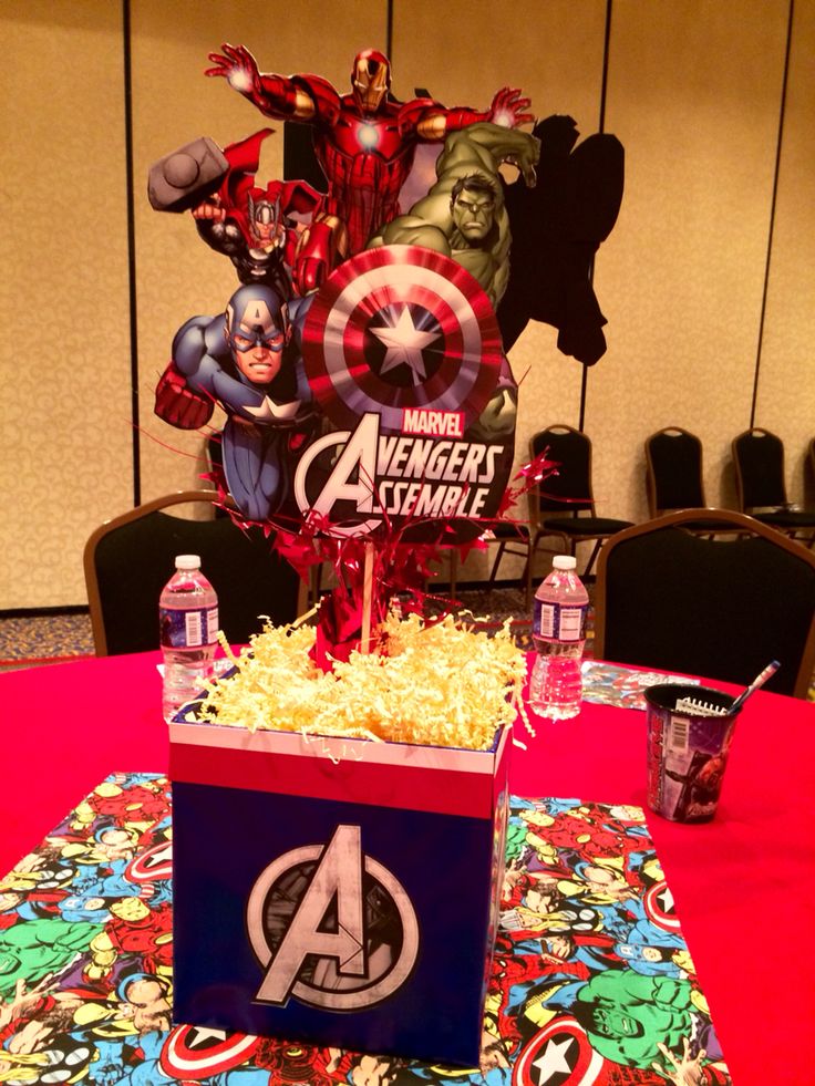 the table is set up for an avengers birthday party