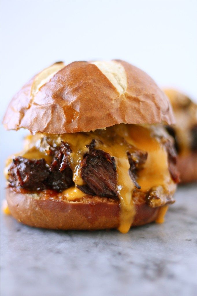 a cheeseburger with meat and melted cheese on it's bun is sitting on the counter