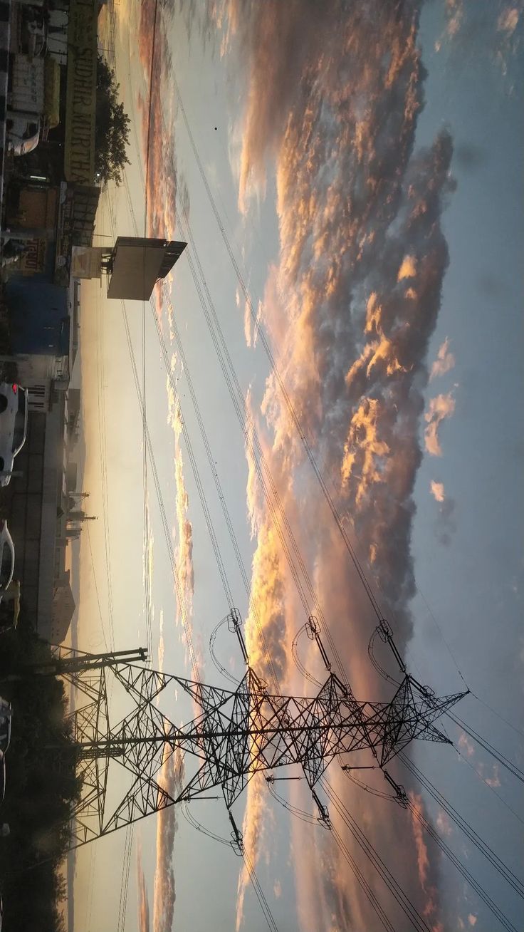 the sky is filled with clouds and power lines