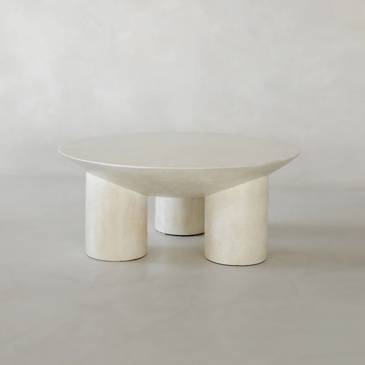 a white table sitting on top of a cement floor