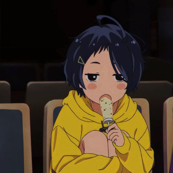 an anime character sitting in a chair holding a microphone