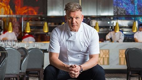 a man sitting on a stool in a restaurant