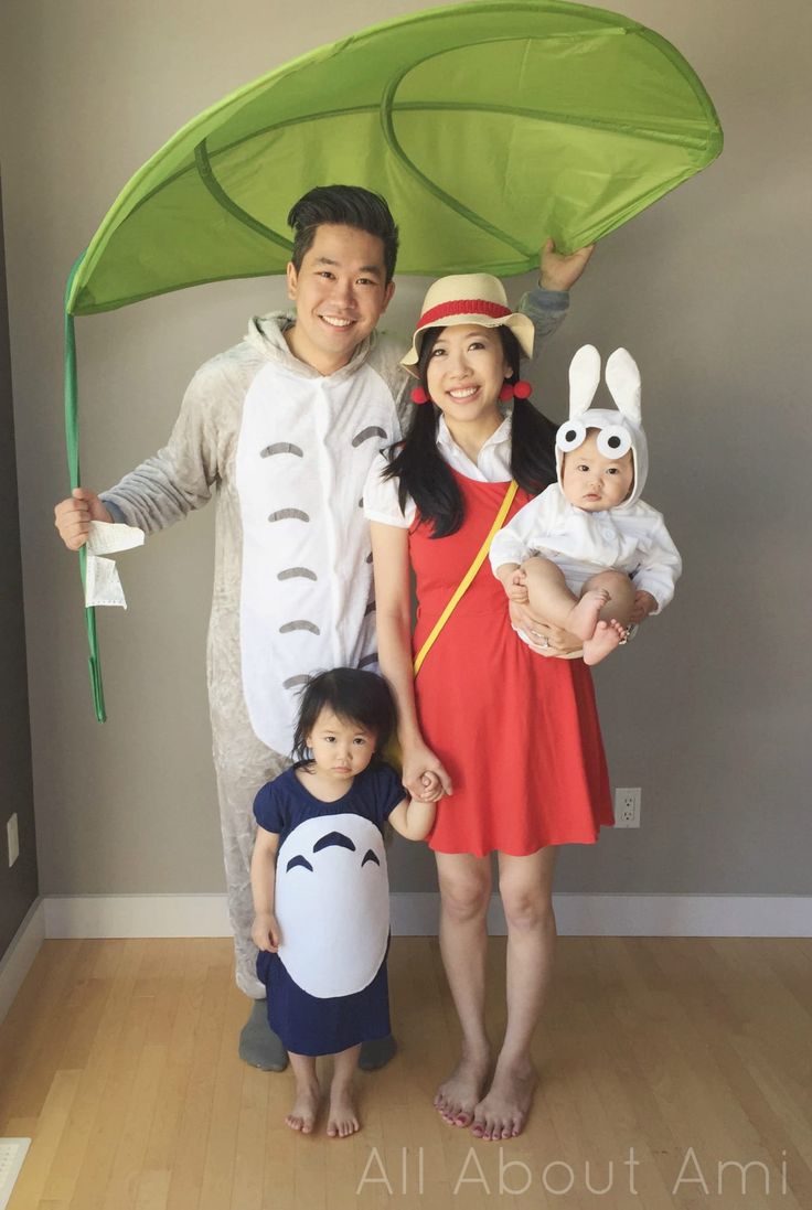 a man and woman with two children dressed in costumes