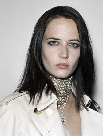 a woman with dark hair wearing a collar necklace