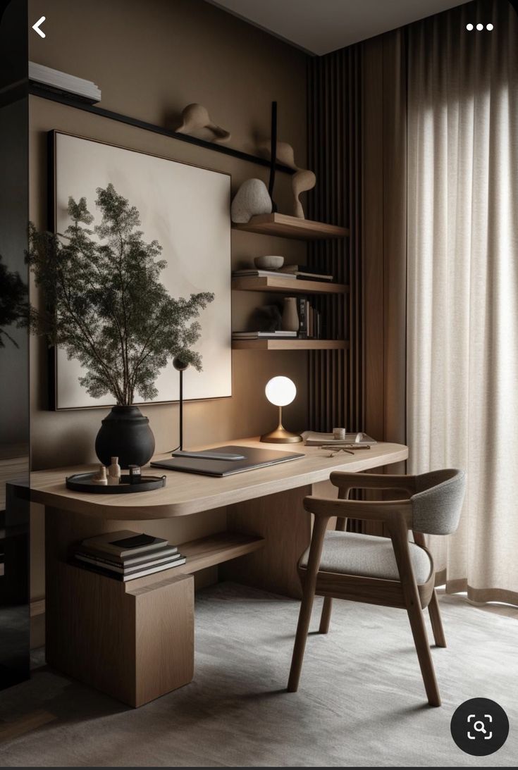 a desk with a chair, lamp and vase on it in front of a window