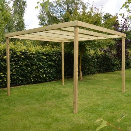 a wooden pergolan in the middle of a yard with green grass and bushes