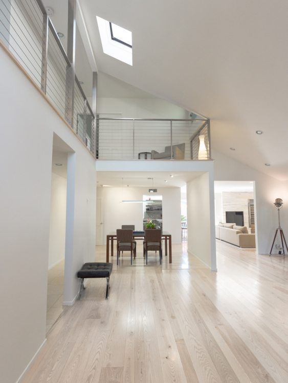 an open floor plan with white walls and wood floors