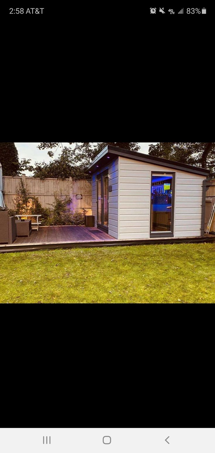 a mobile home is shown in the middle of an open yard with a patio and picnic table