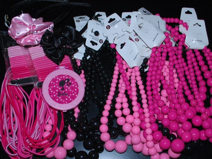 pink and black necklaces are laid out on a table