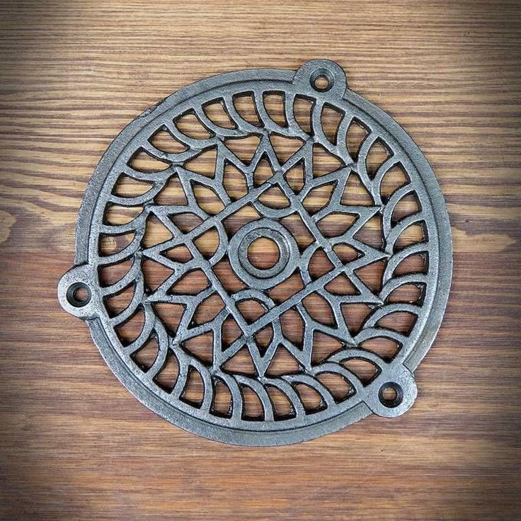 a metal grate sitting on top of a wooden table