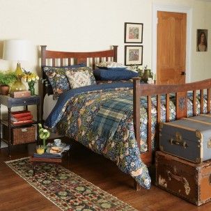 a bed room with a neatly made bed and suitcases