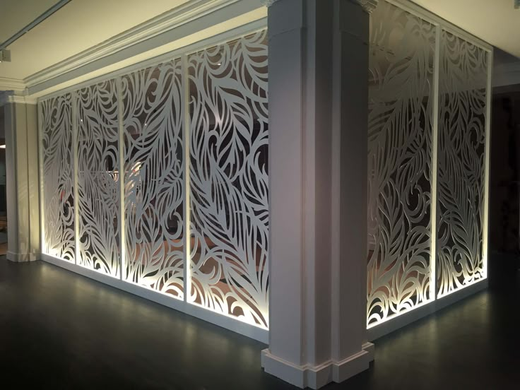 a room divider made out of white paper with laser cut designs on the sides