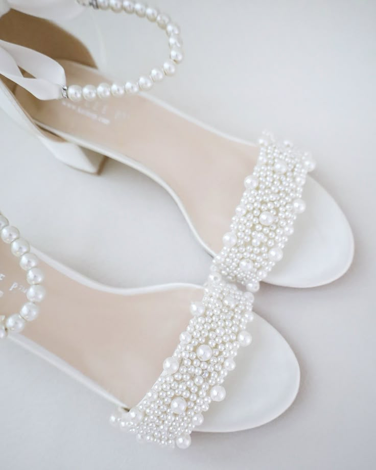 the bridal shoes are adorned with pearls