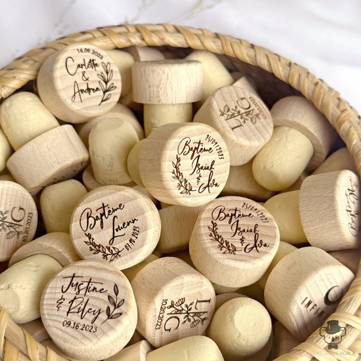 several wine corks in a basket with names on them and date written on them