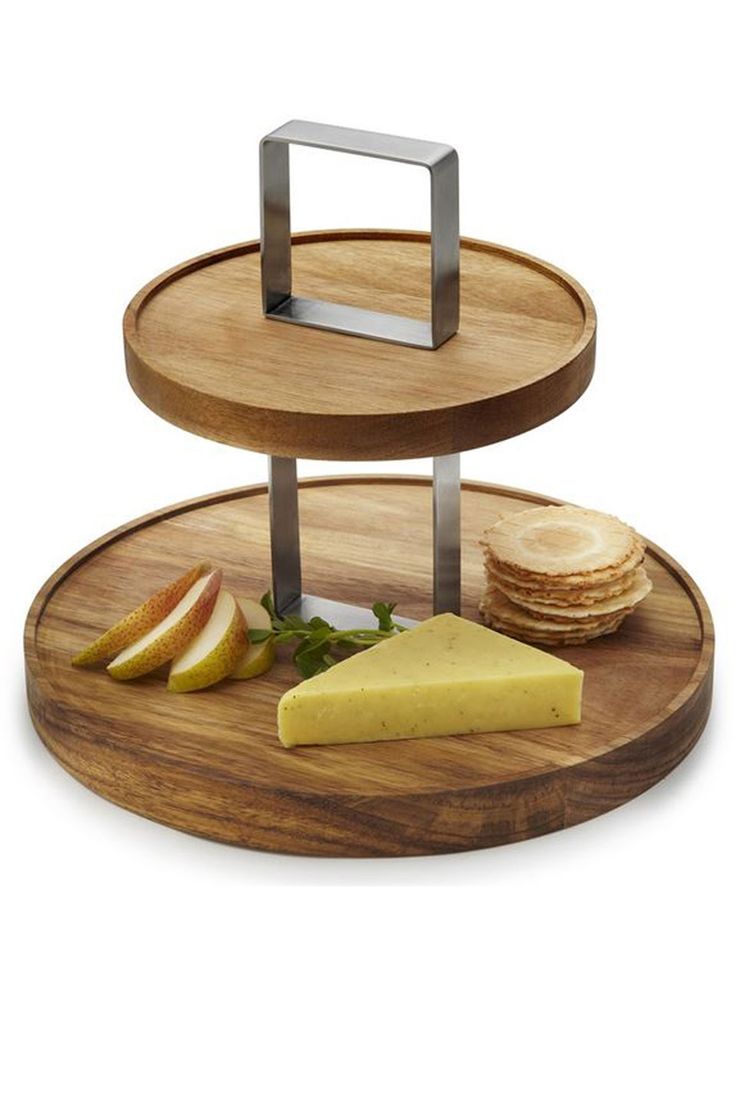 three tiered wooden tray with cheese, crackers and apple slices on the side