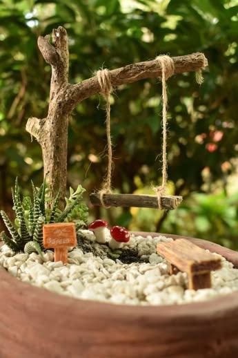 a wooden bowl filled with rocks and plants