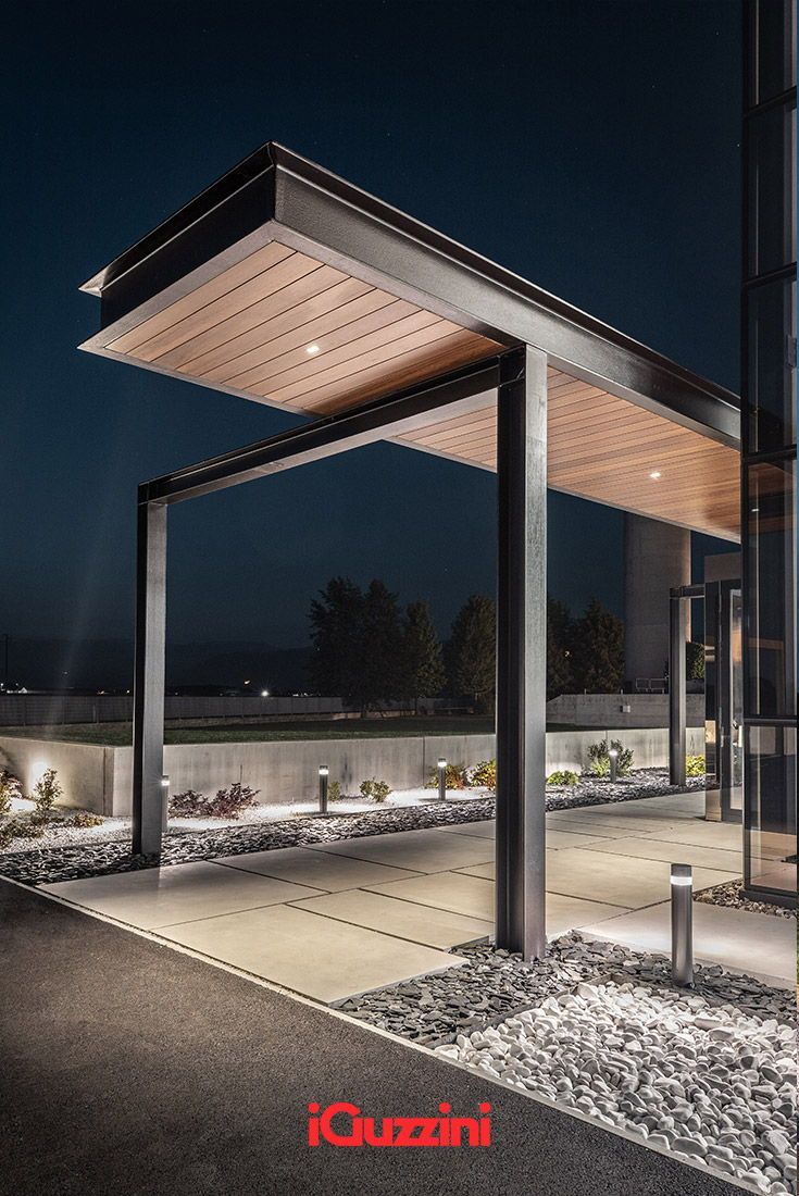 an empty covered parking lot at night with the lights on