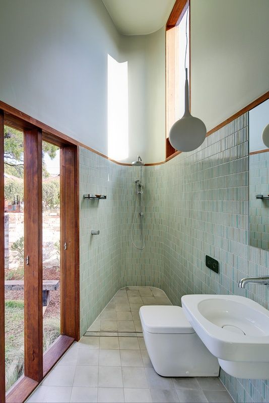 a bathroom with two sinks and large mirrors on the wall next to it's doors