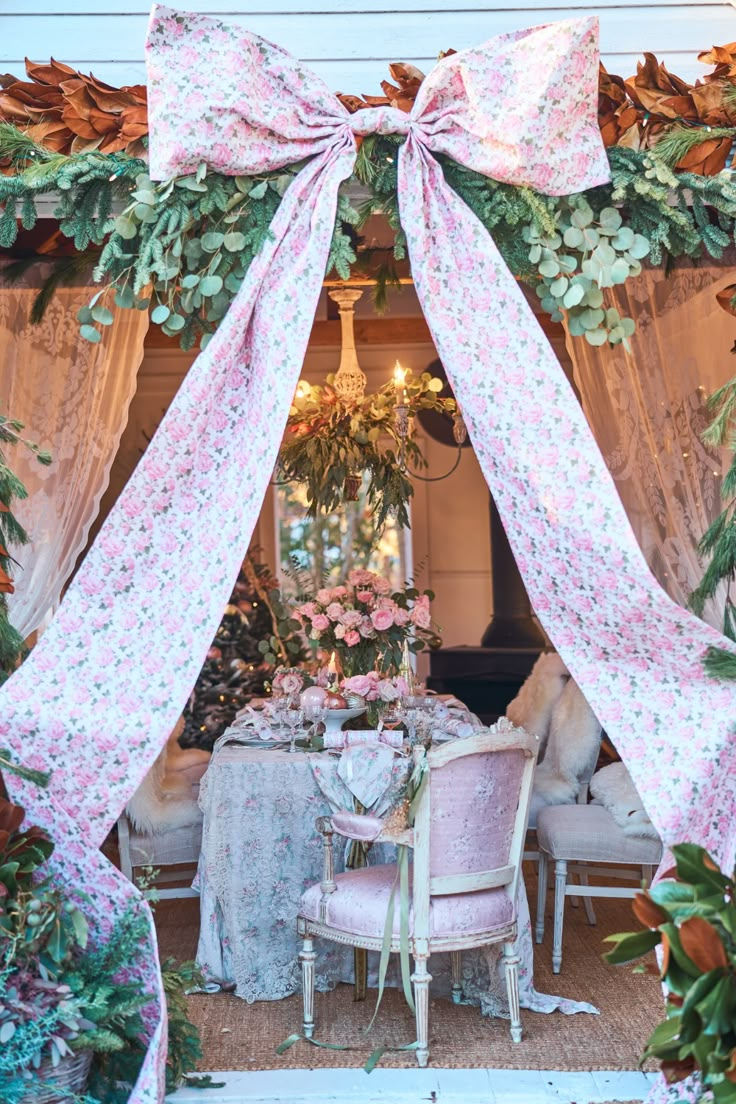 the table is covered with pink flowers and bows