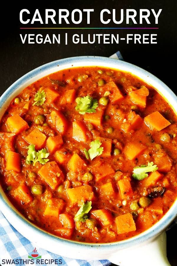 a white bowl filled with carrot curry and broccoli on top of a blue towel