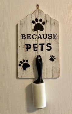 a sign that says because pets is on the wall next to a roll of toilet paper