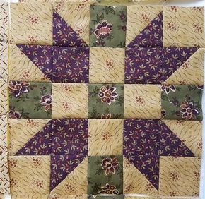 a quilted wall hanging with flowers on it