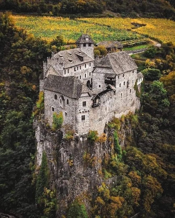 an old castle perched on top of a cliff