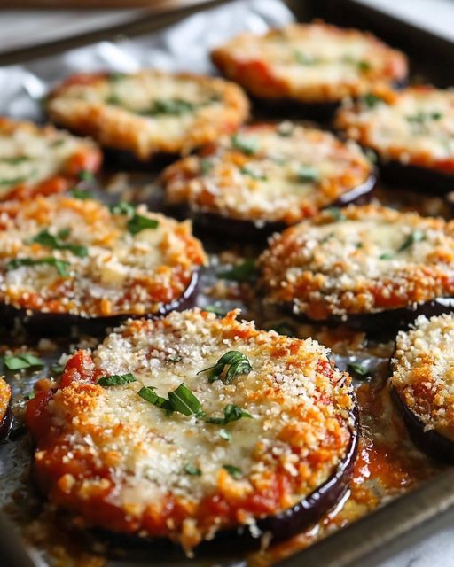 baked eggplant parmesan breaded potatoes on a baking sheet, ready to be eaten