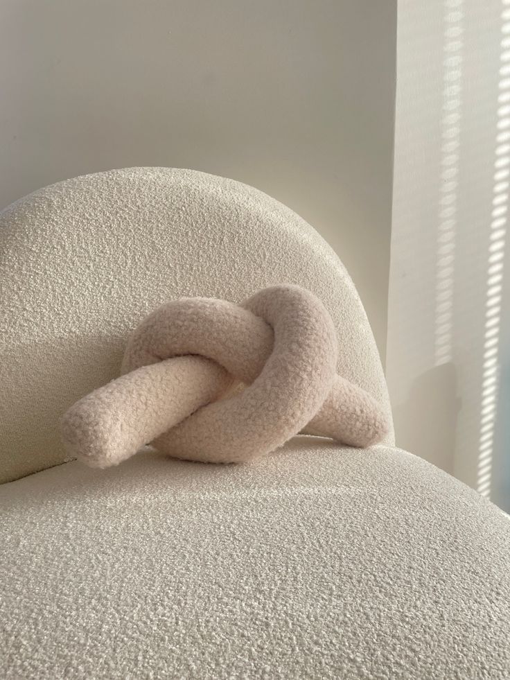 a white chair with a knot on it