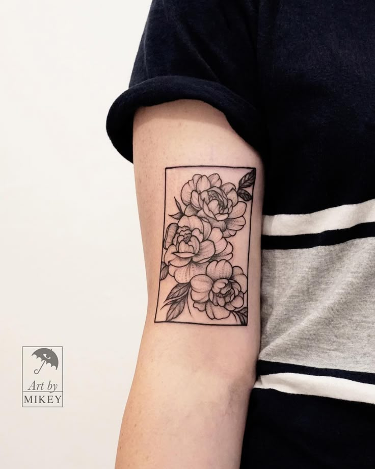 a woman's arm with a flower tattoo on the left side of her arm