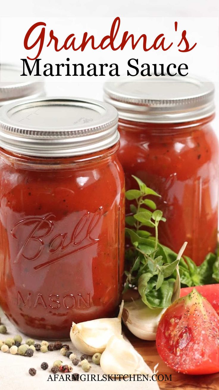 three jars filled with homemade marinara sauce and garnished with herbs on top