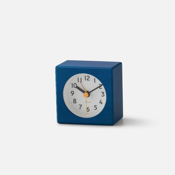 a small blue cube clock on a white background