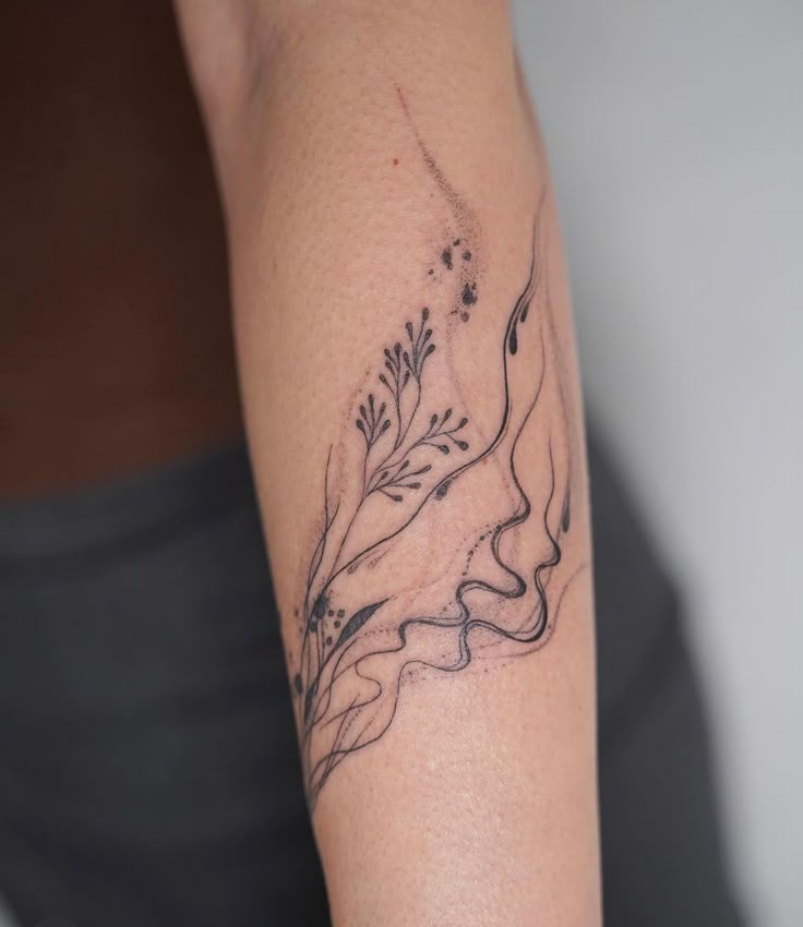 a woman's arm with a tattoo design on the left side of her body