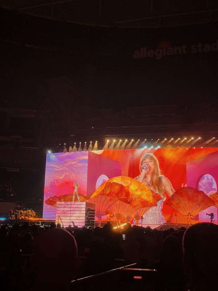 the stage is lit up with orange umbrellas