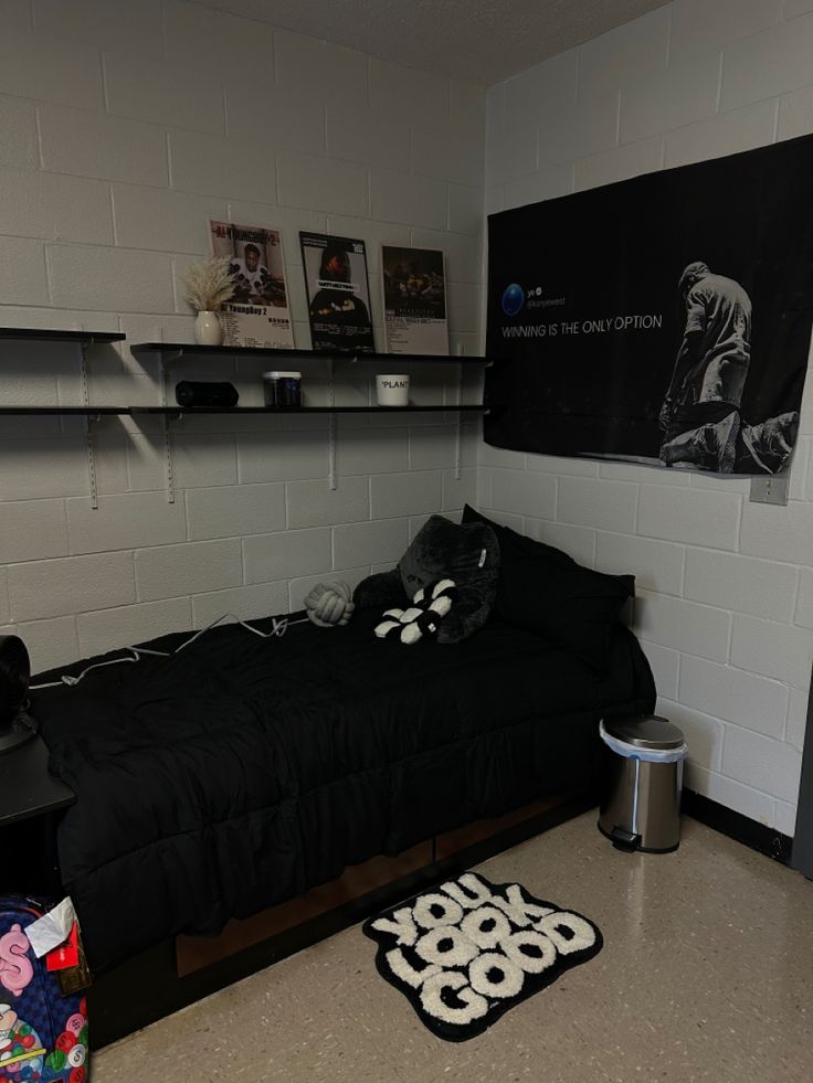 a bedroom with a black bed and white walls