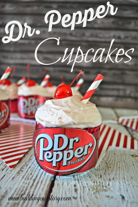 dr pepper cupcakes with whipped cream and cherries on top, sitting on a wooden table