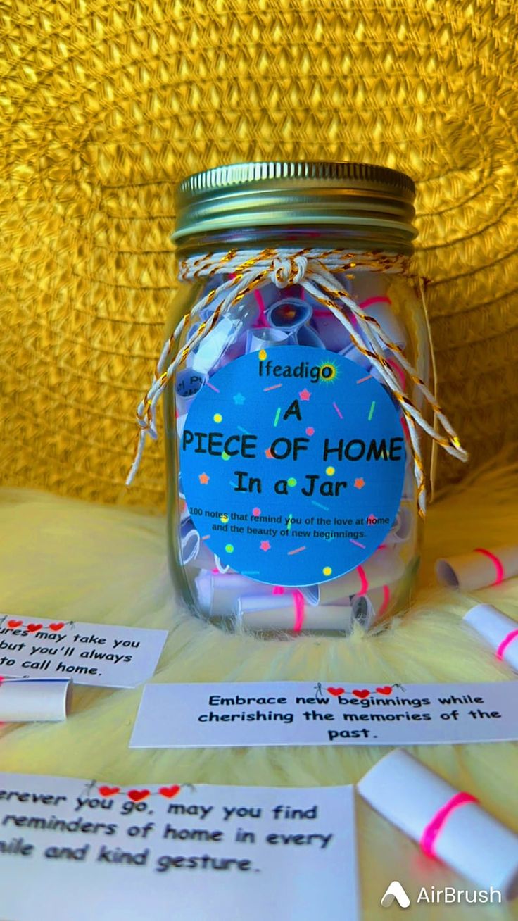 a jar filled with confetti on top of a table next to some paper