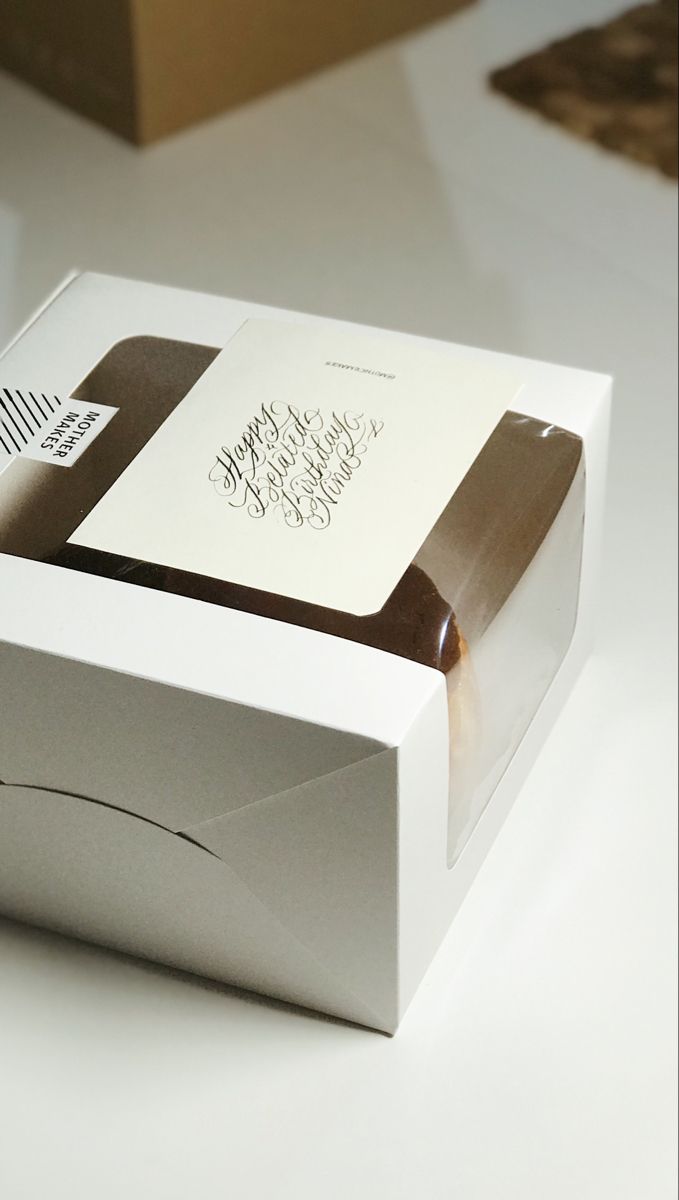 an open white box with some writing on the lid and inside it sitting on a table