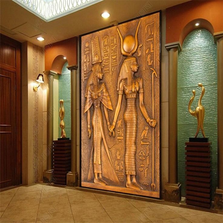 an egyptian themed lobby with statues and lamps