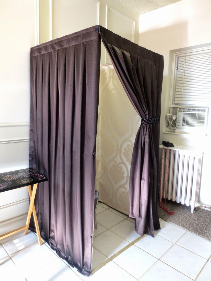 a room with a purple curtain and white tile floor