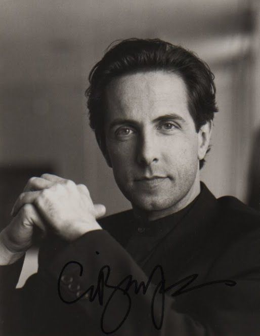 a black and white photo of a man wearing a bow tie