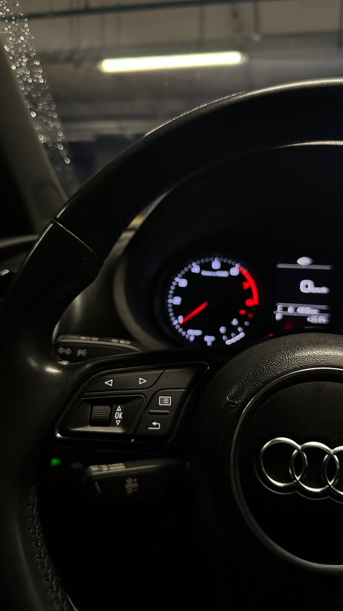 the dashboard of an audi car with red and white numbers on it's gauges